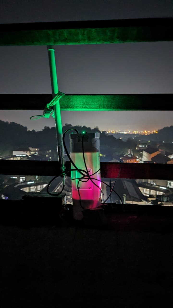 Sensor node operating at night with city lights in background
